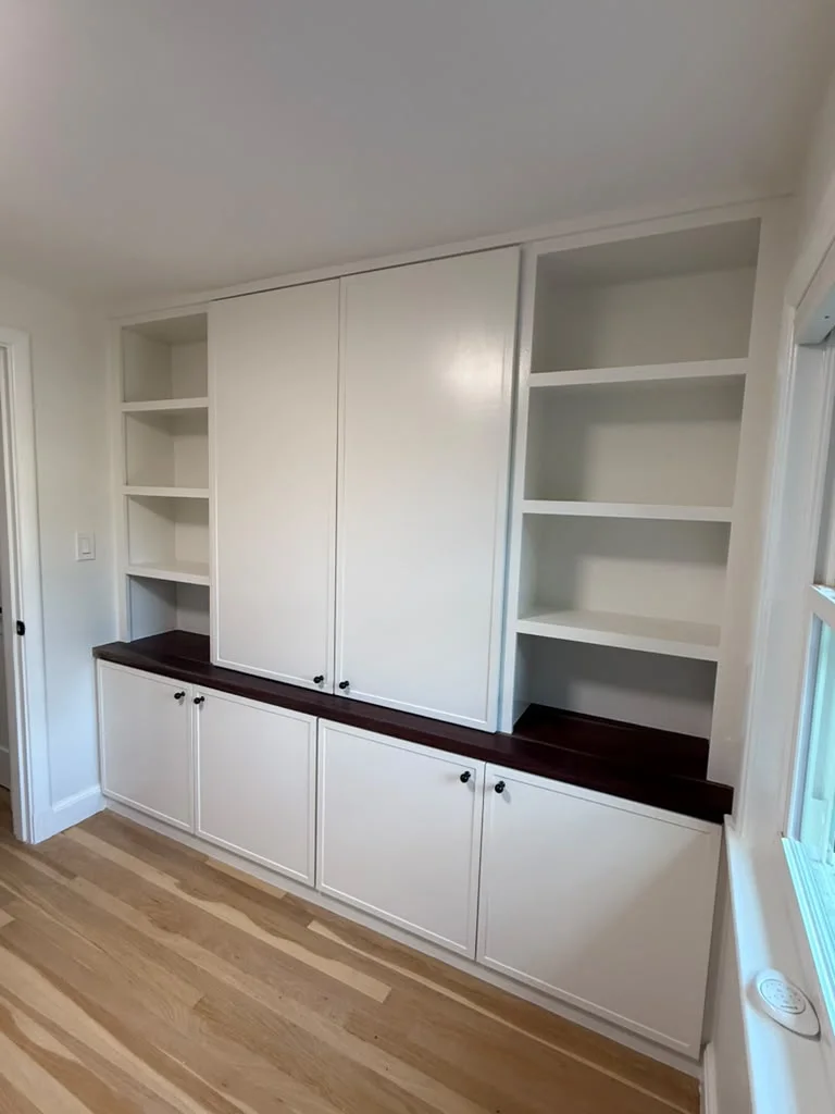Custom Built-in Cabinets in Medford, MA Custom white built-in cabinets with dark wood countertops and light hardwood flooring. by ALP Home Services in Medford, MA
