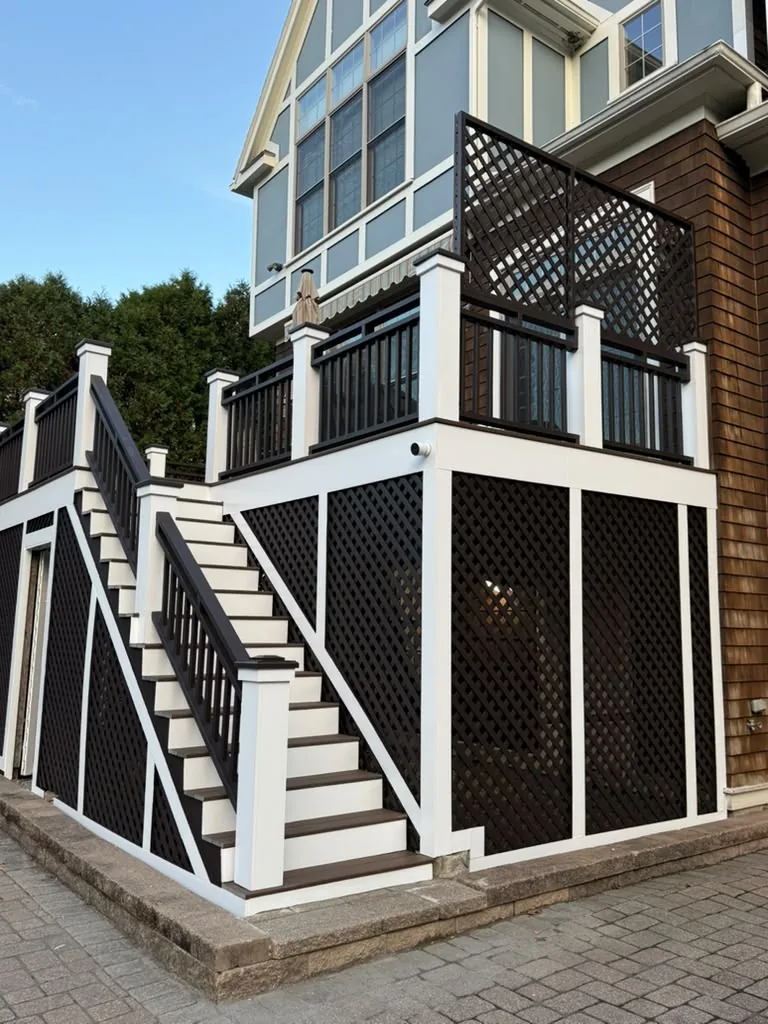 Same deck after two coats of dark brown on the railings and two coats of white on the trim in Newton, MA