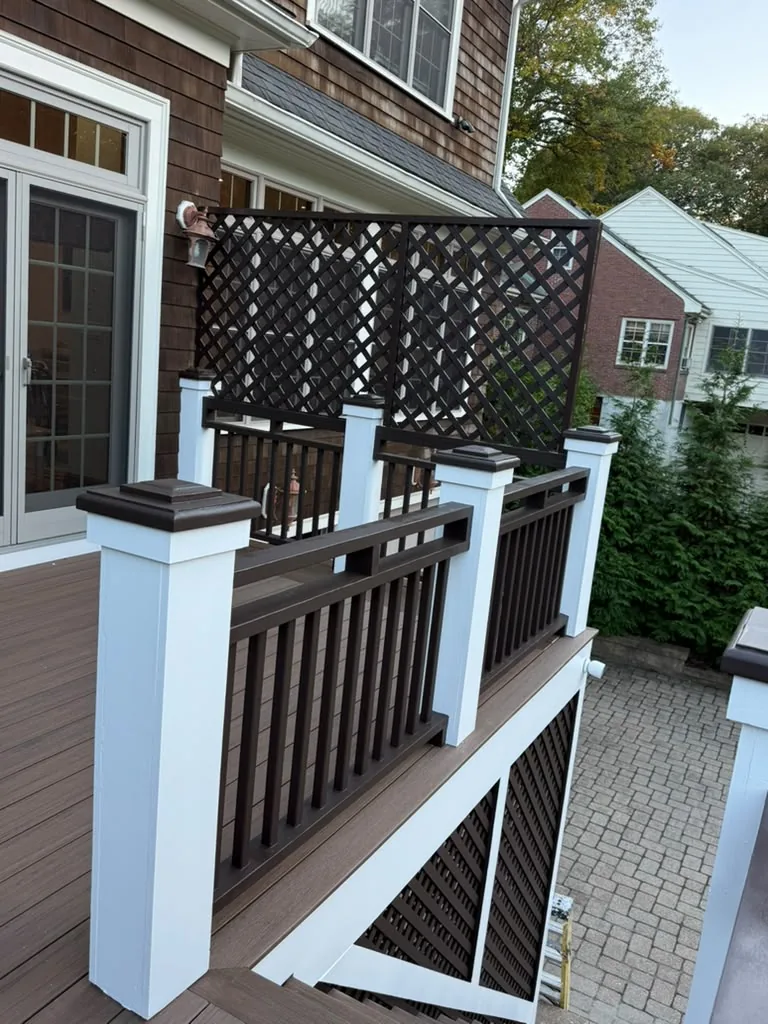 After: dark brown lattice privacy screen and railings with white posts on a Newton, MA deck