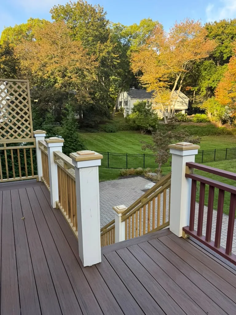 Before: raw wood post caps and stair railing next to older red balusters at the top of the deck stairs