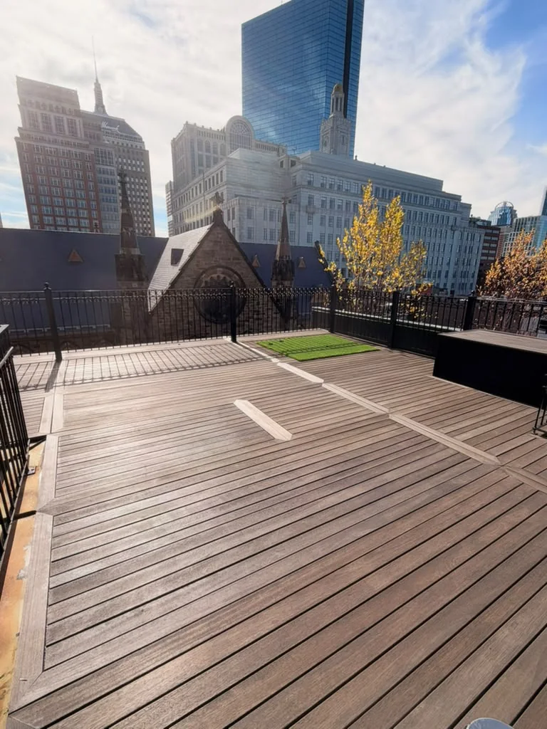 After rooftop deck sealing in Back Bay, Boston: mahogany decking with its warm tone back, sealed by ALP Home Services