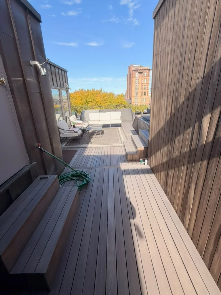 After: sealed mahogany walkway and screen wall leading to the lounge area of a Back Bay rooftop deck