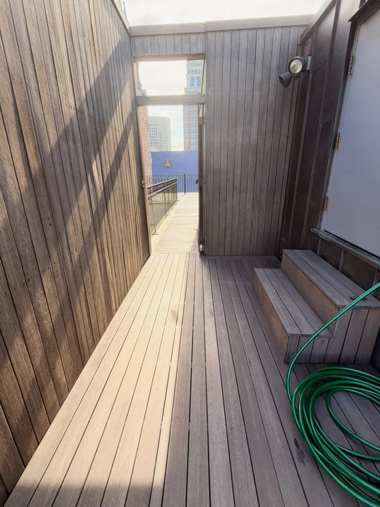 Finished: sealed mahogany walkway, screen wall and steps on a rooftop deck in Back Bay, Boston